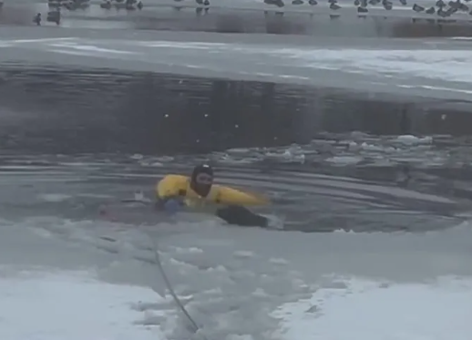 Utah firefighter jumps in freezing pond to rescue growling dog
