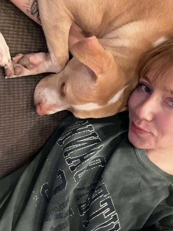 Woman adopts dog left tied up in the rain at NYC subway